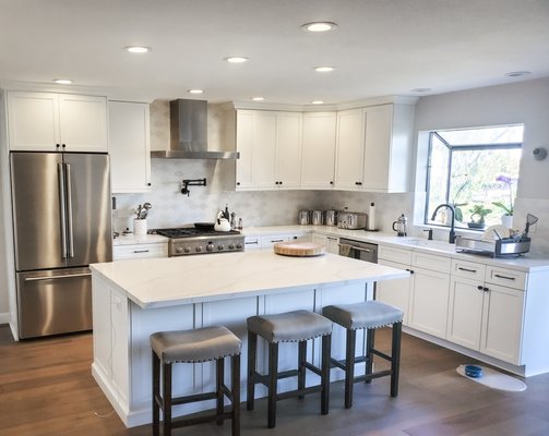Kitchen Design & Remodel - This beautiful kitchen remodel features Kitchen Craft white shaker-style cabinets and crisp, white countertops. These clean, white finishes are balanced nicely with warm wood flooring. Kitchen Design & Remodel - This beautiful kitchen remodel features Kitchen Craft white shaker-style cabinets and crisp, white countertops. These clean, white finishes are balanced nicely with warm wood flooring.