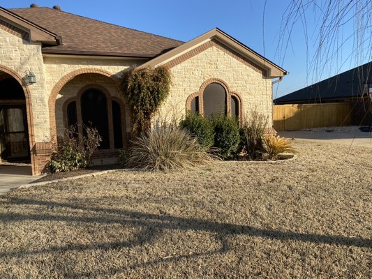 Curb appeal - This project included trimming of bushes and ornamental grasses, cleaning of the beds, and adding fresh brown mulch.