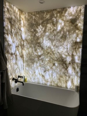 "Backlit Stone Wall + Tub" Beautiful bathroom lighting installation by Bit Electrical, Inc. - Our team powered the backlit stone feature wall and modern fixture setup, creating a warm, luxurious spa‑like atmosphere with clean, precise electrical work.