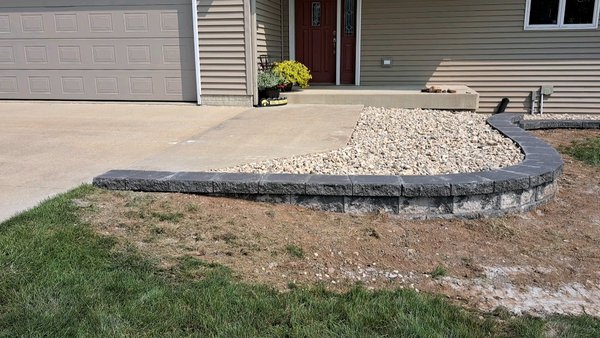 2 tone retaining wall 24 - The customer came to us that they were tired of mowing and weed trimming right up to the house so we did a little retaining wall and made a neat little flower bed behind it to minimize all the little corners for a easy mow 2 tone retaining wall 24 - The customer came to us that they were tired of mowing and weed trimming right up to the house so we did a little retaining wall and made a neat little flower bed behind it to minimize all the little corners for a easy mow