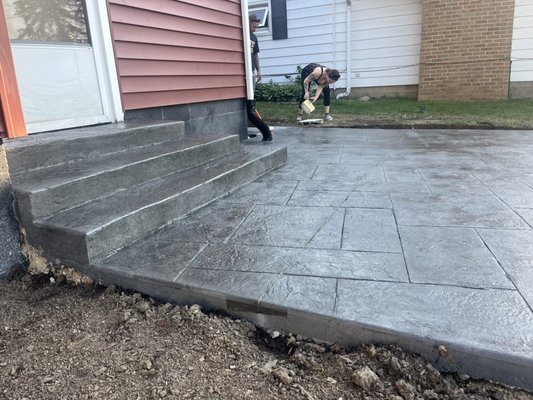 Jim cuyahoga falls - This was a tear out and re pour stamp job that lasted about a week start to finish because of weather and some other constraints. Jim our customer decided to go with a blue ashlar stamp pattern and wedding cake steps. Turned his backyard into a maxing and relaxing oasis !!! Jim cuyahoga falls - This was a tear out and re pour stamp job that lasted about a week start to finish because of weather and some other constraints. Jim our customer decided to go with a blue ashlar stamp pattern and wedding cake steps. Turned his backyard into a maxing and relaxing oasis !!!