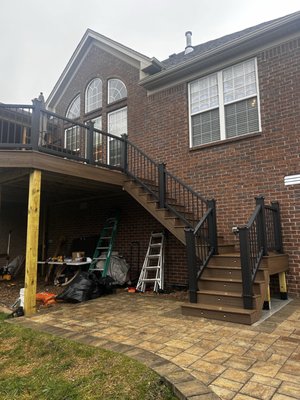 Trex deck repair and staircase installation - This deck was in need of new decking and frame repair. We replaced several of the 6x6 support posts as well as made several repairs to the framing. We then installed Trex RainEscape troughs to waterproof the frame and keep rain off of the porch below. We installed Trex composite decking and a sleek black Trex composite railing to really give this deck new life. A new concrete pad was poured for the staircase, and the staircase was completely torn down and rebuild with lighting installed to complete the project.