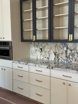 New marble Calacatta Viola Custom Countertops - Calacatta Viola Countertops Installation
The new Calacatta Viola countertops bring unparalleled elegance and luxury to the space, instantly becoming a centerpiece of the design. Key features include:
• Exquisite Marble Pattern: Featuring bold, deep burgundy veining against a creamy white backdrop, Calacatta Viola adds a striking and sophisticated aesthetic.
• Timeless Elegance: This high-end marble offers a classic yet contemporary look, elevating any kitchen or bathroom space.
• Durability: Expertly sealed and polished to enhance the stone’s natural beauty while protecting it from stains and wear.
• Versatile Appeal: The unique color palette pairs beautifully with both neutral and bold cabinetry, creating a dramatic contrast or harmonious blend.
• Custom Craftsmanship: Precision-cut edges and seamless installation ensure a flawless finish that highlights the stone’s natural beauty.
These countertops make a statement, combining functionality and artistry for a truly luxurious upgrade to the space. New marble Calacatta Viola Custom Countertops - Calacatta Viola Countertops Installation
The new Calacatta Viola countertops bring unparalleled elegance and luxury to the space, instantly becoming a centerpiece of the design. Key features include:
• Exquisite Marble Pattern: Featuring bold, deep burgundy veining against a creamy white backdrop, Calacatta Viola adds a striking and sophisticated aesthetic.
• Timeless Elegance: This high-end marble offers a classic yet contemporary look, elevating any kitchen or bathroom space.
• Durability: Expertly sealed and polished to enhance the stone’s natural beauty while protecting it from stains and wear.
• Versatile Appeal: The unique color palette pairs beautifully with both neutral and bold cabinetry, creating a dramatic contrast or harmonious blend.
• Custom Craftsmanship: Precision-cut edges and seamless installation ensure a flawless finish that highlights the stone’s natural beauty.
These countertops make a statement, combining functionality and artistry for a truly luxurious upgrade to the space.