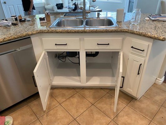Kitchen Sink Cabinet Restoration - On this project we rebuilt and refinished the damaged sink cabinet base, installed new panels and applied fresh paint for a clean updated look. Kitchen Sink Cabinet Restoration - On this project we rebuilt and refinished the damaged sink cabinet base, installed new panels and applied fresh paint for a clean updated look.