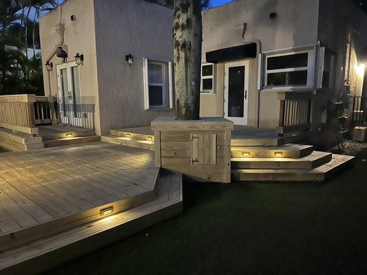 Wood Deck and Artificial Turf - Backyard remodel with custom wood deck and lighting, articulated turf and hardscape.