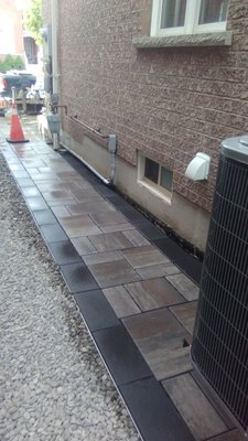 INTERLOCK PATHWAY & FLOWER BED - This interlock pathway was finished in 2021, Markham. We dug out this pathway and filled with gravel, graded away from the house, and tamped it down for 2 hours total then lay the stone.