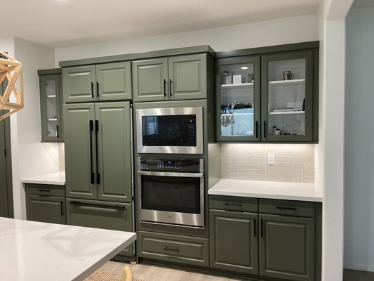 Kitchen Cabinets - Customer originally asked for the cabinets to be green and loved the way they came out and asked for panels on the fridge to match the cabinets as well as making the side cabinets, glass cabinets. Kitchen Cabinets - Customer originally asked for the cabinets to be green and loved the way they came out and asked for panels on the fridge to match the cabinets as well as making the side cabinets, glass cabinets.