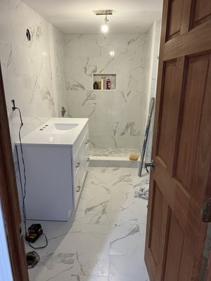 Bathroom Remodeling - Project Spotlight: Modern Marble Sanctuary
We recently completed this comprehensive bathroom remodel, focusing on clean lines, bright aesthetics, and precision craftsmanship. This project perfectly demonstrates our ability to blend elegant design with durable, high-quality installation.
Key Features of This Remodel:
Seamless Marble Tilework: We installed large-format, marble-veined porcelain tiles across the floors and walls to create a cohesive, expansive feel.
Custom Walk-In Shower: The shower features a built-in recessed niche for storage and a coordinated hexagonal tile floor for added texture and slip resistance.
Sleek Modern Vanity: A crisp white floating-style vanity with a minimalist integrated sink provides a sharp, clean contrast to the detailed tilework.
Precision Finishing: Every tile is perfectly leveled and aligned, showcasing the meticulous attention to detail that comes from 27 years of experience.
Transform your outdated bathroom into a spa-like retreat with Tahir Remodeling & Installation. Contact us today for a free estimate on your next home project! Bathroom Remodeling - Project Spotlight: Modern Marble Sanctuary
We recently completed this comprehensive bathroom remodel, focusing on clean lines, bright aesthetics, and precision craftsmanship. This project perfectly demonstrates our ability to blend elegant design with durable, high-quality installation.
Key Features of This Remodel:
Seamless Marble Tilework: We installed large-format, marble-veined porcelain tiles across the floors and walls to create a cohesive, expansive feel.
Custom Walk-In Shower: The shower features a built-in recessed niche for storage and a coordinated hexagonal tile floor for added texture and slip resistance.
Sleek Modern Vanity: A crisp white floating-style vanity with a minimalist integrated sink provides a sharp, clean contrast to the detailed tilework.
Precision Finishing: Every tile is perfectly leveled and aligned, showcasing the meticulous attention to detail that comes from 27 years of experience.
Transform your outdated bathroom into a spa-like retreat with Tahir Remodeling & Installation. Contact us today for a free estimate on your next home project!