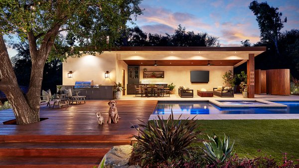 Altadena Foothill Retreat: Award-Winning Modernity Meets Natural Energy - Modern lines and wild foothill energy define this Altadena backyard, a project centered entirely on the beauty of contrast. We paired a formal pool and clean contemporary architecture with an informal, natural landscape so that each element makes the other stand out. The design creates a sophisticated balance between a high-end resort feel and the rugged beauty of the surrounding foothills.
A decomposed granite path winds through boulder walls and alternating timber landscape ties, guiding guests across the lawn and deck toward a sleek outdoor retreat structure. This cabana-style building feels deeply intentional within the surrounding greenery. Because the site originally presented a challenging slope located behind the driveway, we completely reshaped the terrain. We created a visually inviting stairway and leveled the rear zone using layered boulder walls and timbers, finished with informal planting to soften the structural edges.
The retreat structure itself is built for year-round living and seamless indoor-outdoor flow. It features Ipe decking perfectly aligned with the pool deck and open walls that embrace the water. The space is packed with luxury amenities, including an outdoor shower, restroom, and sauna, all finished with a fire pit and ceiling heaters for cool California nights. This project’s unique blend of precision and naturalism earned four California Landscape Contractors Association awards, including top honors for Best Design and Build as well as Best Use of Rockscape. Altadena Foothill Retreat: Award-Winning Modernity Meets Natural Energy - Modern lines and wild foothill energy define this Altadena backyard, a project centered entirely on the beauty of contrast. We paired a formal pool and clean contemporary architecture with an informal, natural landscape so that each element makes the other stand out. The design creates a sophisticated balance between a high-end resort feel and the rugged beauty of the surrounding foothills.
A decomposed granite path winds through boulder walls and alternating timber landscape ties, guiding guests across the lawn and deck toward a sleek outdoor retreat structure. This cabana-style building feels deeply intentional within the surrounding greenery. Because the site originally presented a challenging slope located behind the driveway, we completely reshaped the terrain. We created a visually inviting stairway and leveled the rear zone using layered boulder walls and timbers, finished with informal planting to soften the structural edges.
The retreat structure itself is built for year-round living and seamless indoor-outdoor flow. It features Ipe decking perfectly aligned with the pool deck and open walls that embrace the water. The space is packed with luxury amenities, including an outdoor shower, restroom, and sauna, all finished with a fire pit and ceiling heaters for cool California nights. This project’s unique blend of precision and naturalism earned four California Landscape Contractors Association awards, including top honors for Best Design and Build as well as Best Use of Rockscape.