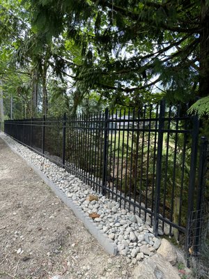 Ornamental Iron Fence in Snohomish - With a $20,000 budget, our team constructed an elegant black metal fence that brought sophistication and security to a luxury mansion's uneven front yard. In just four days, we turned a challenging landscape into a visually appealing, secure property border.