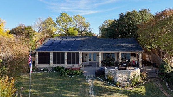 Solar Roof in Arlington, TX - Customer wanted to go green energy and needed a new roof due to storm damage. We installed this 10KW solar roof system so now the roof works for the homeowner.