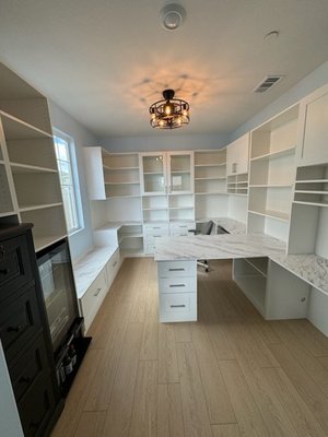 Office Built Around You - We transformed this room into a full office that included a peninsula desk, bench seating, 5-Piece Shaker drawers and doors made in-house, while incorporating the clients existing dresser and fridge!