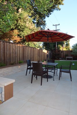 Backyard Remodel - This backyard was transformed into a clean and functional outdoor living space. We installed a spacious concrete patio, artificial turf, and a custom retaining wall with built-in seating. The finished project provides a low-maintenance area perfect for relaxing, dining, and entertaining guests. Backyard Remodel - This backyard was transformed into a clean and functional outdoor living space. We installed a spacious concrete patio, artificial turf, and a custom retaining wall with built-in seating. The finished project provides a low-maintenance area perfect for relaxing, dining, and entertaining guests.