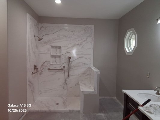 Primary Shower w/ Obscure Glass surround - We removed a garden tub and made the shower larger and replaced the floor throughout the bathroom. Primary Shower w/ Obscure Glass surround - We removed a garden tub and made the shower larger and replaced the floor throughout the bathroom.