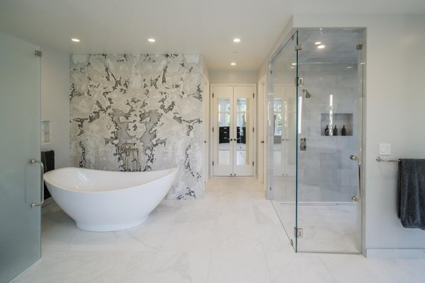 Multi Bathroom Remodel - Complete Remodel of Primary / Kid's Bathrooms, Powder Room and Entry. We absolutely love the Book-matched slabs in the Primary!!