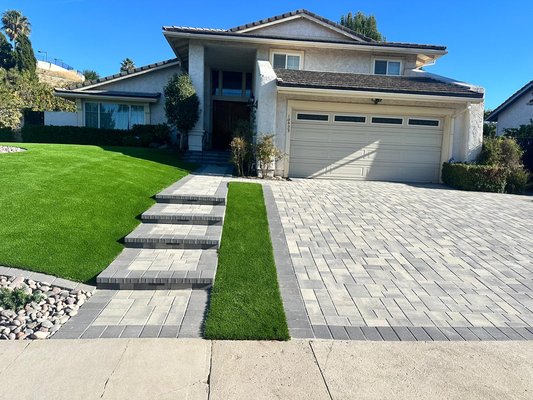 Front Yard Pavers & Turf - Full front-yard renovation featuring pavers installation in Porter Ranch. This project included a brand-new light-gray paver driveway, upgraded step walkway, premium artificial turf with gopher-wire protection, updated planter areas, landscape rock accents, low-voltage lighting, and a full drainage system for long-term durability. Clean, modern, and built to last. Front Yard Pavers & Turf - Full front-yard renovation featuring pavers installation in Porter Ranch. This project included a brand-new light-gray paver driveway, upgraded step walkway, premium artificial turf with gopher-wire protection, updated planter areas, landscape rock accents, low-voltage lighting, and a full drainage system for long-term durability. Clean, modern, and built to last.