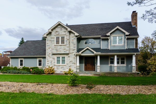 Full Exterior Remodel - Stone Siding & James Hardie Siding in Lincolnshire, IL - Homeowners moved into their home and wanted to update the appearance. This complete exterior renovation includes Siding, Windows, Entry Door, Garage Doors, Porch and Balcony. We worked with them and took the time to first review renderings to approve the design before pulling the trigger on this amazing exterior transformation.
On home and garage, we installed James HardiePlank Lap Siding in Cedarmill finish, Versetta Stone Siding (on front elevation) and HardieTrim NT3 trim boards (and Corners) with Color Plus Technology factory paint finish in Custom Color. Custom bent aluminum flashings and proper drainage in Picture frame style.
Entry Door: Provia fiberglass door with sidelight/s. Mahogany skin in color nutmeg, Bronze Emtek handle, craftsman style.
Balcony: Removed existing decking on rear balcony and replaced with new Azek composite decking and installed new railing.
Porch: Removed existing porch and install new porch for an updated yet traditional look. All new roofing, new concrete stoop and Versetta stone with composite posts as well as ceiling material. Full Exterior Remodel - Stone Siding & James Hardie Siding in Lincolnshire, IL - Homeowners moved into their home and wanted to update the appearance. This complete exterior renovation includes Siding, Windows, Entry Door, Garage Doors, Porch and Balcony. We worked with them and took the time to first review renderings to approve the design before pulling the trigger on this amazing exterior transformation.
On home and garage, we installed James HardiePlank Lap Siding in Cedarmill finish, Versetta Stone Siding (on front elevation) and HardieTrim NT3 trim boards (and Corners) with Color Plus Technology factory paint finish in Custom Color. Custom bent aluminum flashings and proper drainage in Picture frame style.
Entry Door: Provia fiberglass door with sidelight/s. Mahogany skin in color nutmeg, Bronze Emtek handle, craftsman style.
Balcony: Removed existing decking on rear balcony and replaced with new Azek composite decking and installed new railing.
Porch: Removed existing porch and install new porch for an updated yet traditional look. All new roofing, new concrete stoop and Versetta stone with composite posts as well as ceiling material.
