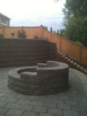 Retaining wall with built in bench and fire pit - We cleared the entire area and constructed a multi-tier wall system and patio with integrated stairs and benches, complete with coping/caps. Additionally, you completed the landscape installation, including the irrigation system. Retaining wall with built in bench and fire pit - We cleared the entire area and constructed a multi-tier wall system and patio with integrated stairs and benches, complete with coping/caps. Additionally, you completed the landscape installation, including the irrigation system.