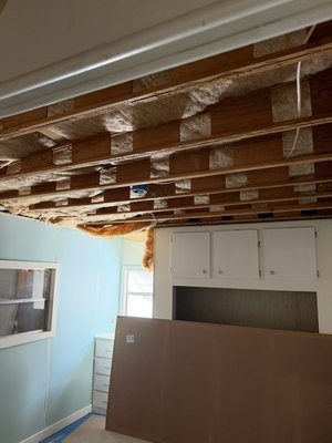 Beadboard ceiling installation - Scope of Work
Phase 1: Demolition, Removal, and Preparation
 Ceiling Removal: Complete removal and proper disposal of the existing damaged drywall or ceiling material.
 Insulation Extraction: Safe removal and disposal of all damaged or contaminated fiberglass insulation.
 Inspection & Cleaning: Cleaning the exposed ceiling cavity and inspecting joists and framing for structural integrity, moisture, or pest issues prior to closing.
Phase 2: Insulation and Framing Prep
 New Insulation: Supply and installation of new fiberglass thermal insulation, properly secured between joists.
 Framing Leveling: Securing and leveling the wooden structure to ensure a smooth, even surface for the new ceiling material.
Phase 3: Finish Ceiling Installation & Trims
 Panels Installation: Installation of tongue-and-groove / beadboard ceiling panels (PVC or wood) across the target ceiling area.
 Perimeter Molding: Precision installation of crown or wall trim moldings along the perimeter to cover expansion gaps and deliver a clean edge.
 Beam Trim: Encasing and finishing the central divider beam to match the updated ceiling design seamlessly.
 Final Touches: Caulking all joints, filling nail holes, and applying touch-up white paint for a clean, professional finish.
