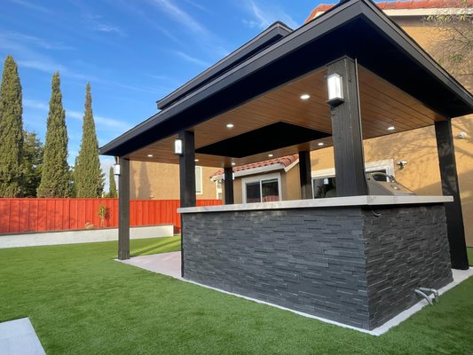 Garden Gazebo - Modern Outdoor Gazebo Project
We transformed this backyard with a sleek, custom-built gazebo featuring LED recessed lighting, a wood-accented ceiling, and a striking stone-faced outdoor bar. Perfect for entertaining, this structure adds style, comfort, and value to the home. We also cleaned the backyard and installed new synthetic grass. Garden Gazebo - Modern Outdoor Gazebo Project
We transformed this backyard with a sleek, custom-built gazebo featuring LED recessed lighting, a wood-accented ceiling, and a striking stone-faced outdoor bar. Perfect for entertaining, this structure adds style, comfort, and value to the home. We also cleaned the backyard and installed new synthetic grass.