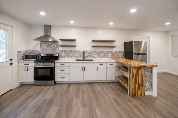 Center St Kitchen Remodel - This kitchen remodel was all about creating a space that looks great and works better for everyday living. We updated everything from the cabinets and countertops to the backsplash, flooring, lighting, and fixtures. The custom wood breakfast bar and floating shelves add a unique touch that really brings the whole kitchen together. We love how this project turned out, and the finished space feels much brighter, more open, and ready to be enjoyed for years to come.