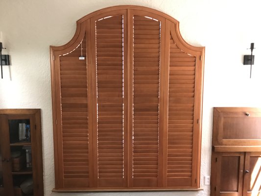 Spanish Style Bungalow - This spanish style home had the most beautiful historic window shape and we wanted to preserve that beauty. These plantation style shutters in a rich wood stain was the perfect solution.