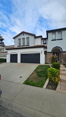 Beautiful Exterior Transformation In Roseville - We did a full exterior transformation on this project by not only painting the home but painting their roof black.  We combined neutral tones for a modern look. White for the main body color,black for the trim and two grey accent walls in the front of the home.