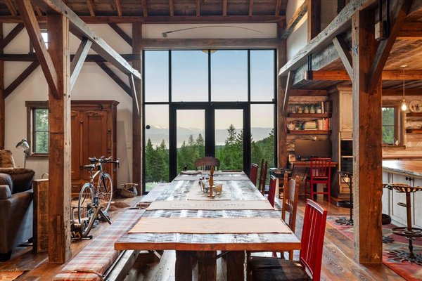 Re-imanged Farmstead - Scenic Views & Endless Potential. A quintessential Montana Farmstead nestled on 15.6 acres of beautifully forested acreage near the end of the road within 3 miles from Flathead Lake and Forest Service. This one-of-a-kind property features a fully restored historic barn, originally from Hot Springs, MT. Carefully relocated and re-imagined, this home is more than a structure—it's a showpiece of craftsmanship, character, and country charm. The 3 bedroom and 2-1/2 bath homestead spanning 2,374 sqft includes original windmill, farm implements forged into fixtures & lighting, to the 1932 Glenwood cookstove, with a 1894 solid copper kitchen sink, beautiful Chestnut & Copper countertops turns the gourmet kitchen into a perfect blend of rustic style with modern comfort. The master bathroom also features uniquely designed lighting, a vanity with antique hand forged branding iron legs, copper sinks and a copper soaking tub.
A series of single and double tree horse tack along with a collection of barn lanterns come together as a rustic chandelier illuminates the remarkable walnut tree spiral staircase spanning all levels in the silo. Two bedrooms with huge closets and antique wrought iron beds in the basement along with spacious laundry closet and full bath with walk-in shower complete this peaceful charming home in the woods. Whether you're relaxing or entertaining, the beauty of Montana is always front and center. The property includes repurposed silos, creatively designed to serve as unique outdoor entertaining spaces—perfect for gatherings, events, or peaceful evenings under the stars. Alongside the Farmstead is a 28x28 2 bay garage and a 24x24 foundation, fully prepared for your next build—be it a guest home, workshop, or main residence. Stone paths lead you out to the landscaped yard with fruit trees, fur, pine, western larch and there is a 22x50 fenced garden with organic soil surrounded by natural landscape filled with wildlife and privacy. Property trees have been thinned & fire mitigated by forest professionals and DNRC Family forest program. There is a generator for the house to keep all your modern day comforts operational. The home is being sold TurnKey for your immediate enjoyment. Welcome to Hummingbird Hollow, a story waiting to be continued. Re-imanged Farmstead - Scenic Views & Endless Potential. A quintessential Montana Farmstead nestled on 15.6 acres of beautifully forested acreage near the end of the road within 3 miles from Flathead Lake and Forest Service. This one-of-a-kind property features a fully restored historic barn, originally from Hot Springs, MT. Carefully relocated and re-imagined, this home is more than a structure—it's a showpiece of craftsmanship, character, and country charm. The 3 bedroom and 2-1/2 bath homestead spanning 2,374 sqft includes original windmill, farm implements forged into fixtures & lighting, to the 1932 Glenwood cookstove, with a 1894 solid copper kitchen sink, beautiful Chestnut & Copper countertops turns the gourmet kitchen into a perfect blend of rustic style with modern comfort. The master bathroom also features uniquely designed lighting, a vanity with antique hand forged branding iron legs, copper sinks and a copper soaking tub.
A series of single and double tree horse tack along with a collection of barn lanterns come together as a rustic chandelier illuminates the remarkable walnut tree spiral staircase spanning all levels in the silo. Two bedrooms with huge closets and antique wrought iron beds in the basement along with spacious laundry closet and full bath with walk-in shower complete this peaceful charming home in the woods. Whether you're relaxing or entertaining, the beauty of Montana is always front and center. The property includes repurposed silos, creatively designed to serve as unique outdoor entertaining spaces—perfect for gatherings, events, or peaceful evenings under the stars. Alongside the Farmstead is a 28x28 2 bay garage and a 24x24 foundation, fully prepared for your next build—be it a guest home, workshop, or main residence. Stone paths lead you out to the landscaped yard with fruit trees, fur, pine, western larch and there is a 22x50 fenced garden with organic soil surrounded by natural landscape filled with wildlife and privacy. Property trees have been thinned & fire mitigated by forest professionals and DNRC Family forest program. There is a generator for the house to keep all your modern day comforts operational. The home is being sold TurnKey for your immediate enjoyment. Welcome to Hummingbird Hollow, a story waiting to be continued.