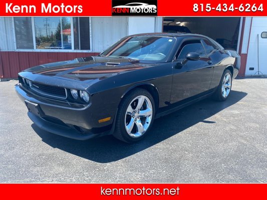 2013 Dodge Challenger SXT - Step into this sleek black 2013 Dodge Challenger and feel the power beneath your feet. With a 3.6L V6 VVT engine purring under the hood, this Challenger is ready to hit the open road. Whether you're cruising down the highway or revving it up in the city, the independent touring suspension gives you a smooth ride every time. The body-color fascias and bright fuel filler door add a touch of style, while the leather-wrapped steering wheel and shift knob provide a luxurious feel. 2013 Dodge Challenger SXT - Step into this sleek black 2013 Dodge Challenger and feel the power beneath your feet. With a 3.6L V6 VVT engine purring under the hood, this Challenger is ready to hit the open road. Whether you're cruising down the highway or revving it up in the city, the independent touring suspension gives you a smooth ride every time. The body-color fascias and bright fuel filler door add a touch of style, while the leather-wrapped steering wheel and shift knob provide a luxurious feel.