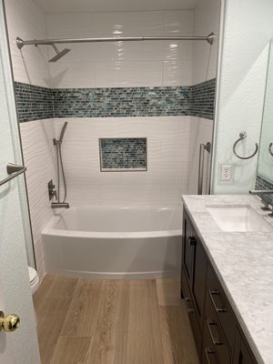 New bathroom - The upstairs bathroom flooded so out with the old and in with new. New soaking bathtub and tile surround. 
New flooring and vanity were also installed.