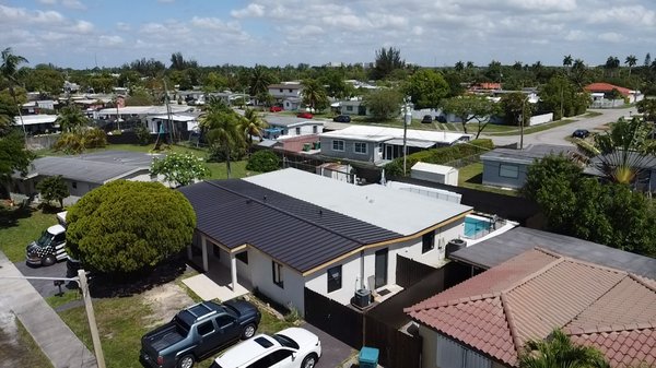 Metal Roof Installation – Residential Property in Miami, FL - We recently completed a premium standing seam metal roof installation on this beautiful home in Miami. The project involved removing the old roofing system, reinforcing the deck, and installing a modern, energy-efficient metal roof with a sleek finish. Our team prioritized both aesthetics and performance, ensuring superior protection against Florida’s harsh weather.