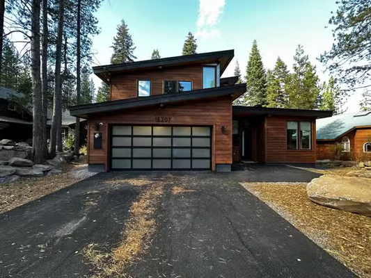 New Garage Doors Installed - We recently had the pleasure of enhancing a residence in Truckee, CA, with the installation of a sophisticated 18x8 full-view glass garage door. This exquisite door features sleek black glass set in a robust black frame, providing a modern look that boosts both the aesthetic appeal and value of the home. Designed to blend seamlessly with the property's contemporary architecture, this door not only elevates the home’s exterior but also offers durability and improved energy efficiency. Ideal for homeowners seeking to merge style with functionality, our installation ensures a stunning, maintenance-free addition that complements the scenic Truckee surroundings. New Garage Doors Installed - We recently had the pleasure of enhancing a residence in Truckee, CA, with the installation of a sophisticated 18x8 full-view glass garage door. This exquisite door features sleek black glass set in a robust black frame, providing a modern look that boosts both the aesthetic appeal and value of the home. Designed to blend seamlessly with the property's contemporary architecture, this door not only elevates the home’s exterior but also offers durability and improved energy efficiency. Ideal for homeowners seeking to merge style with functionality, our installation ensures a stunning, maintenance-free addition that complements the scenic Truckee surroundings.