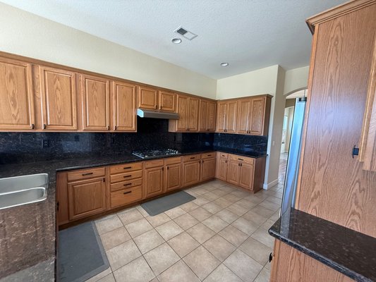 Kitchen Cabinet Transformation - A complete kitchen transformation featuring freshly painted cabinets, updated hardware, and a clean, refreshed finish throughout the space.