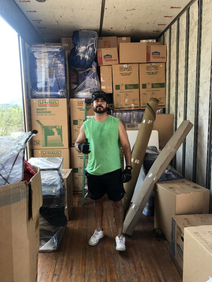 Tucson Compass Movers crew member inside a loaded moving truck