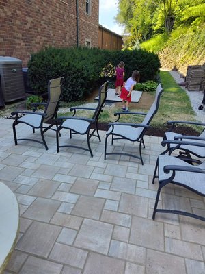 Patio replacement - We turned a bumpy trip hazard into a classy hang out spot! The client said that no one would go out back and look at her beautiful flowers. After the new patio was installed, it hosted many events.