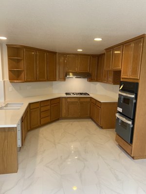 KITCHEN - From a water leak under the sink to a beautiful upgraded kitchen with new tile floor install and new countertop and backsplash.