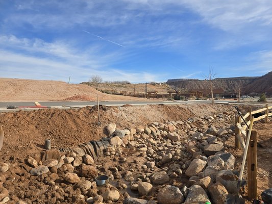Gravel Parking Lot Installation & Drainage Prep - This project included full site prep and installation of a gravel parking lot with proper grading for drainage. We excavated, leveled, and compacted the base before spreading and shaping road base/gravel for long-term durability. Rock work and erosion control were added along the roadside to manage runoff and protect the area. The finished lot provides a smooth, solid surface built to handle regular vehicle traffic. Gravel Parking Lot Installation & Drainage Prep - This project included full site prep and installation of a gravel parking lot with proper grading for drainage. We excavated, leveled, and compacted the base before spreading and shaping road base/gravel for long-term durability. Rock work and erosion control were added along the roadside to manage runoff and protect the area. The finished lot provides a smooth, solid surface built to handle regular vehicle traffic.