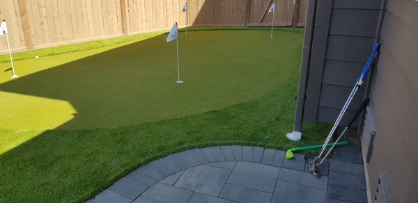 Putting Green - Installing a putting green in your backyard offers a multitude of benefits. It provides convenient access to practice your golf game at any time, improving your skills and enjoyment of the sport. Beyond personal improvement, it fosters family entertainment, promotes outdoor activity for better health, and encourages socialization with friends and neighbors. With customizable designs and low maintenance requirements, a backyard putting green offers year-round availability and adds value to your property. Ultimately, it's a space for personal enjoyment, bringing the joy of golf right to your doorstep. Putting Green - Installing a putting green in your backyard offers a multitude of benefits. It provides convenient access to practice your golf game at any time, improving your skills and enjoyment of the sport. Beyond personal improvement, it fosters family entertainment, promotes outdoor activity for better health, and encourages socialization with friends and neighbors. With customizable designs and low maintenance requirements, a backyard putting green offers year-round availability and adds value to your property. Ultimately, it's a space for personal enjoyment, bringing the joy of golf right to your doorstep.