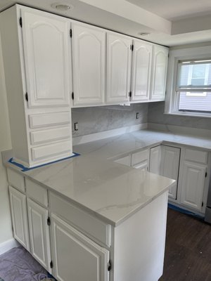 Kitchen Cabinet Painting - Kitchen cabinets, originally finished with a natural stain, were prepped and painted (White). Kitchen Cabinet Painting - Kitchen cabinets, originally finished with a natural stain, were prepped and painted (White).