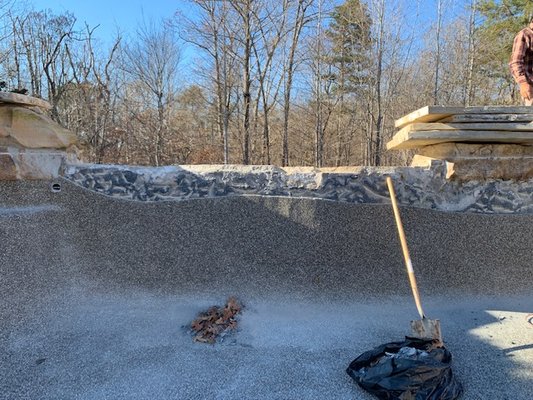 Hembree Project - This was a very complicated project on a very high end pool built in the Canton area. This client had a vanishing edge pool, and the vanishing edge was not properly built and waterproofed. As a result the top 8"-12" of the plaster and shell has disconnected from the rest of the shell and rock-face of the vanishing edge. It was complicated, but we had to tear it apart, repair the shell, waterproof it, and replace both the pebble surface and the adjacent rock-face. But it ended up beautiful, and you would never know! Hembree Project - This was a very complicated project on a very high end pool built in the Canton area. This client had a vanishing edge pool, and the vanishing edge was not properly built and waterproofed. As a result the top 8"-12" of the plaster and shell has disconnected from the rest of the shell and rock-face of the vanishing edge. It was complicated, but we had to tear it apart, repair the shell, waterproof it, and replace both the pebble surface and the adjacent rock-face. But it ended up beautiful, and you would never know!