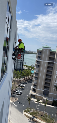 Rope access post construction clean - This was a project in Ft Meyers of one of our Rope Techs doing a post construcion window clean out of a bosuns chair.