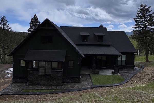 Evergreen Project - Transformed an evergreen property with a sturdy retaining wall, elegant paver paths and steps, a charming planter bed, and artificial turf for zero-maintenance greenery