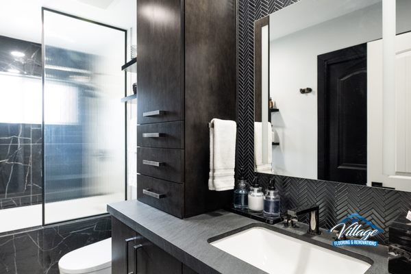 Modern Black & White Bathroom Renovation - This complete bathroom remodel combines contemporary design with high-end functionality. The space features custom dark wood cabinetry, dramatic black herringbone tile accents, marble-look wall tile, a frameless glass shower enclosure, integrated storage solutions, and premium plumbing fixtures. Designed to maximize storage while creating a clean, modern aesthetic, this bathroom delivers both luxury and everyday practicality. Modern Black & White Bathroom Renovation - This complete bathroom remodel combines contemporary design with high-end functionality. The space features custom dark wood cabinetry, dramatic black herringbone tile accents, marble-look wall tile, a frameless glass shower enclosure, integrated storage solutions, and premium plumbing fixtures. Designed to maximize storage while creating a clean, modern aesthetic, this bathroom delivers both luxury and everyday practicality.