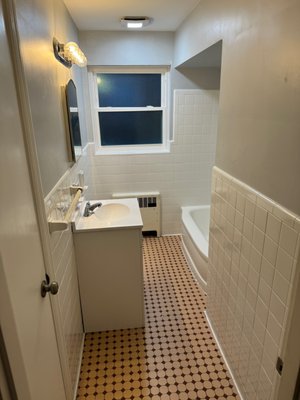 Bathroom Color change - This reglazing was done on an old pink and mauve bathroom. Everything was reglazed to white for a modern look.