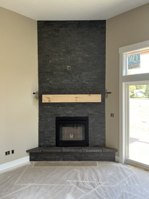 Fireplace Ledger Stone - This Stone Fireplace Wall was installed in a new construction home. 22" square tiles onto hearth. Fireplace was prepped for proper depth and height prior to beginning stone installation. Ledger stone went all the way to the ceiling. Fireplace Ledger Stone - This Stone Fireplace Wall was installed in a new construction home. 22" square tiles onto hearth. Fireplace was prepped for proper depth and height prior to beginning stone installation. Ledger stone went all the way to the ceiling.