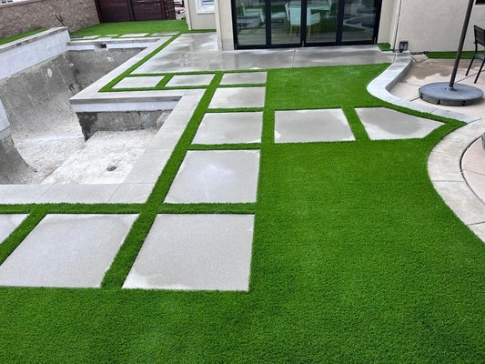 Pool coping and concrete finish with turf. - This was a  backyard project. We did the concrete stepers and added artificial turf to give a more reviving look as the natural grass does but without all the waste of water and money of it .The client stated he was very happy & pleased with our professional service.