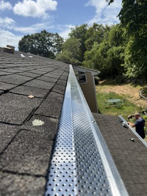 Gutter screen install - We prepped gutters by removing all product inside them and flushed out downspouts then installed the screens Gutter screen install - We prepped gutters by removing all product inside them and flushed out downspouts then installed the screens