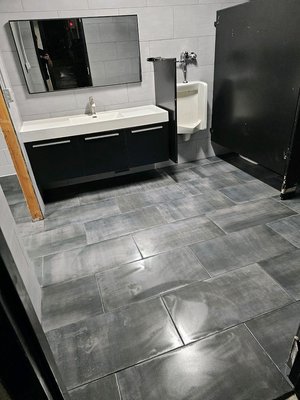 Commercial Bathroom and Shower Remodel - This was a remodel on a commercial bathroom that included a shower and storage room! We tiled the entire floor and all of the walls besides in the closet! Center pitched drain in the shower with unique shower floor tile.