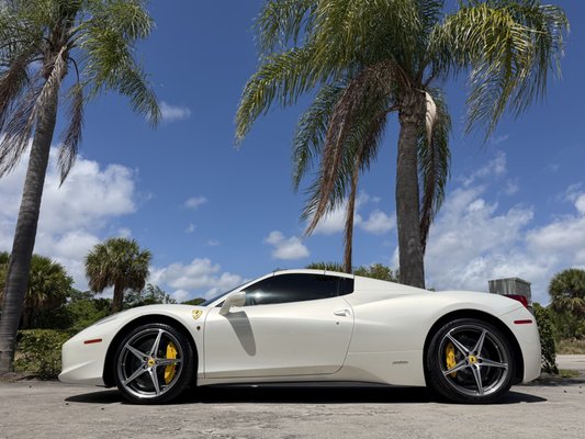 Ferrari 458 Italia — Full Paint Protection Film | PPF | Ceramic Coating | Ceramic Window Tint | Filmwave West Palm Beach - Ferrari 458 Italia — Full PPF & Ceramic Coating | Filmwave West Palm Beach
This stunning white Ferrari 458 Italia came to Filmwave for a full protective treatment worthy of an exotic. We performed a complete paint protection film installation covering the entire vehicle, shielding every panel, edge, and high-impact zone from rock chips, road debris, bug acids, and UV damage. The self-healing PPF ensures that light surface scratches disappear on their own, keeping the paint looking factory fresh.
Following the PPF installation, we applied a professional-grade ceramic coating over the film, dramatically enhancing the depth and gloss of the pearl white finish while adding a hydrophobic layer that repels water, dirt, and contaminants. The result is a wet, mirror-like shine that's effortless to maintain.
Window tinting was also performed to complete the build, reducing heat and UV exposure inside the cabin while giving the 458 a sleek, blacked-out contrast against the white paint.
From the sculpted front fascia to the rear diffuser, every inch of this 458 Italia is protected and perfected — exactly how a Ferrari deserves to be treated.
Services Performed:
Paint Protection Film (Full Body) · Ceramic Coating · Window Tint
