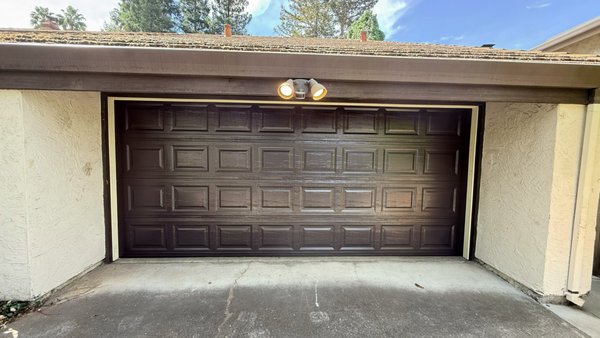Tilt-Up to Sectional Door Conversion in Carmichael - This Carmichael homeowner had an old one-piece wood tilt-up door that was heavy, worn out, and hard to operate. We removed it and installed a brand new sectional door with a brown finish and raised panels that fits the style of the house.
Switching from a tilt-up to a sectional door means smoother operation, a better seal, and more usable space in the garage since the door rolls up along the ceiling instead of swinging out. It also looks a lot cleaner from the street.
Thinking about replacing an old wood door? Give us a call for a free estimate. We install new garage doors across the Sacramento area. Tilt-Up to Sectional Door Conversion in Carmichael - This Carmichael homeowner had an old one-piece wood tilt-up door that was heavy, worn out, and hard to operate. We removed it and installed a brand new sectional door with a brown finish and raised panels that fits the style of the house.
Switching from a tilt-up to a sectional door means smoother operation, a better seal, and more usable space in the garage since the door rolls up along the ceiling instead of swinging out. It also looks a lot cleaner from the street.
Thinking about replacing an old wood door? Give us a call for a free estimate. We install new garage doors across the Sacramento area.